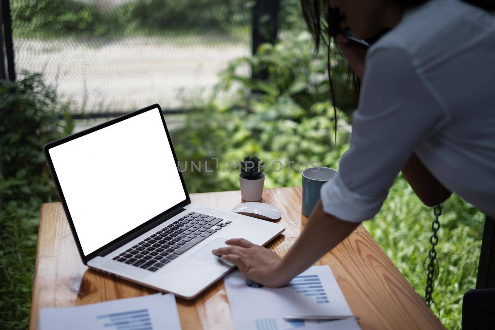 Close-up of a businesswoman using a laptop computer to audit the company's budget. Tax information is calculated by accountants.