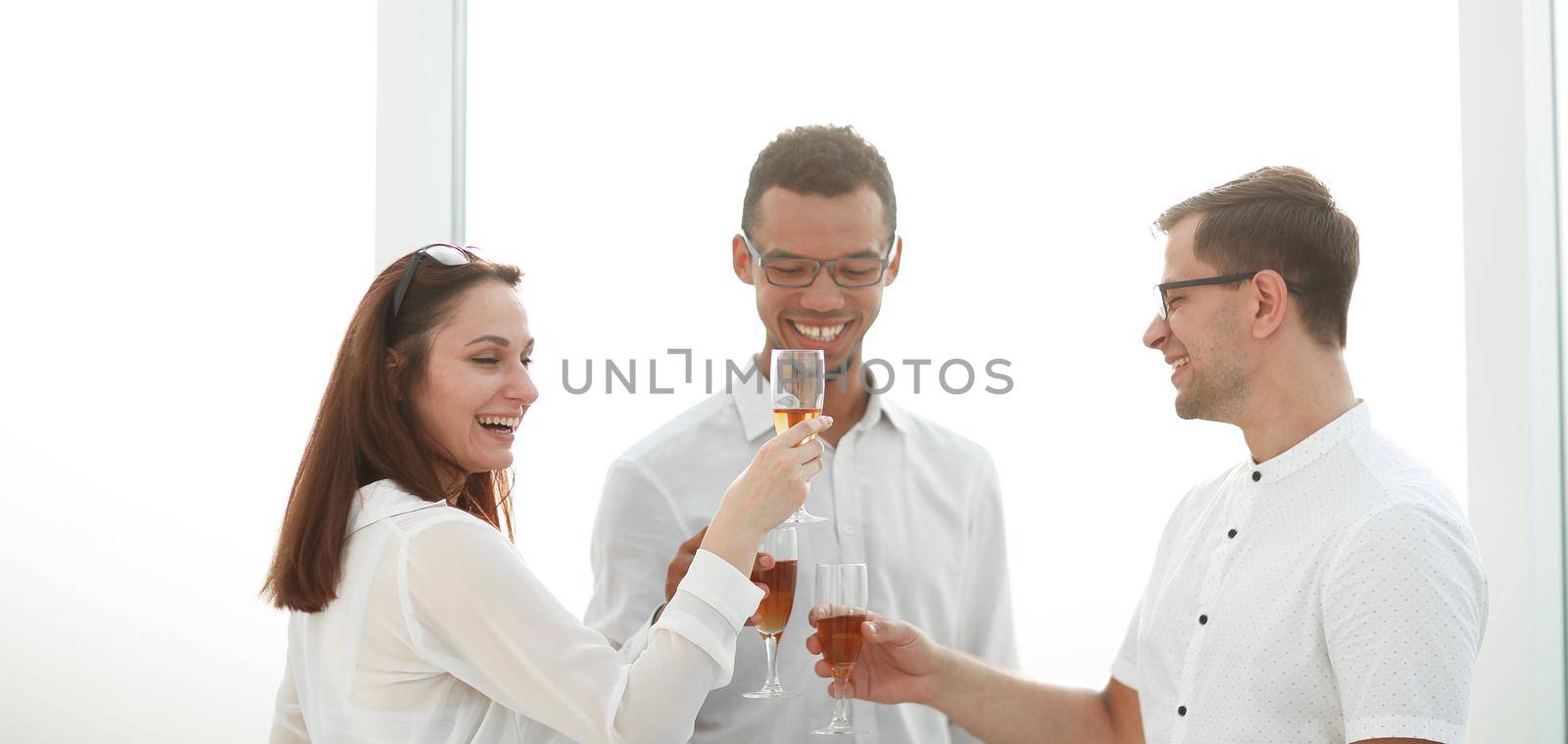 close up.business team clinking glasses of wine by SmartPhotoLab