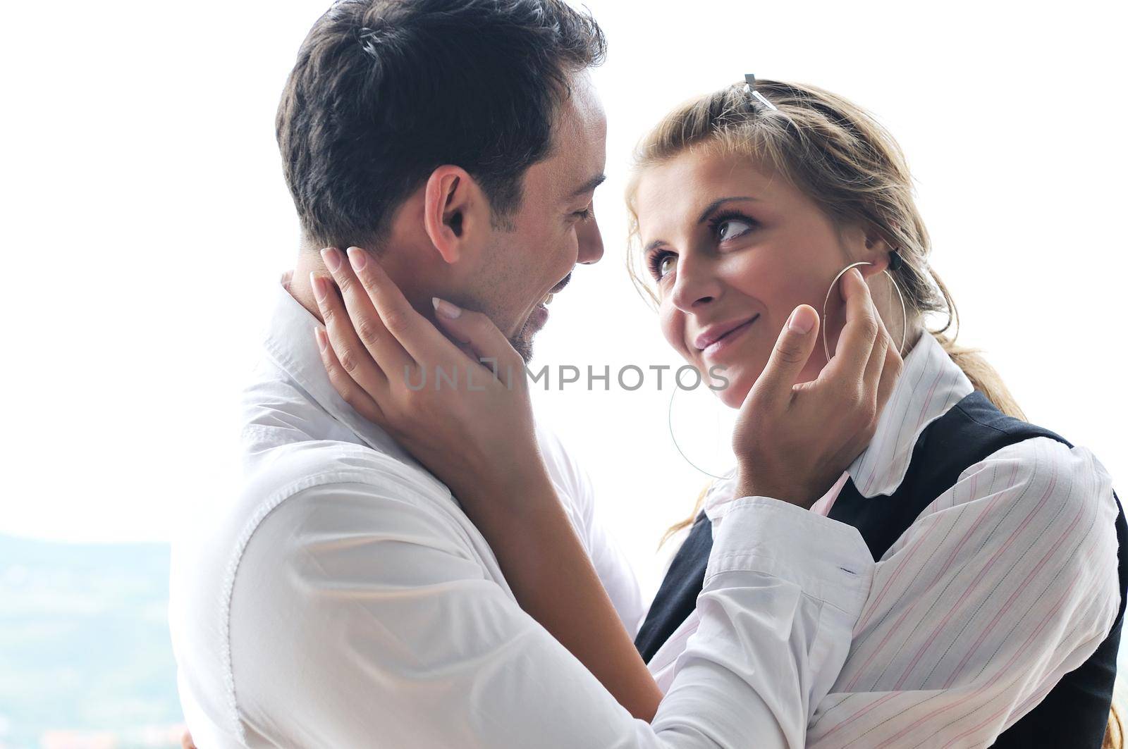 romantic happy couple relax and have fun at balcony in their new home apartment