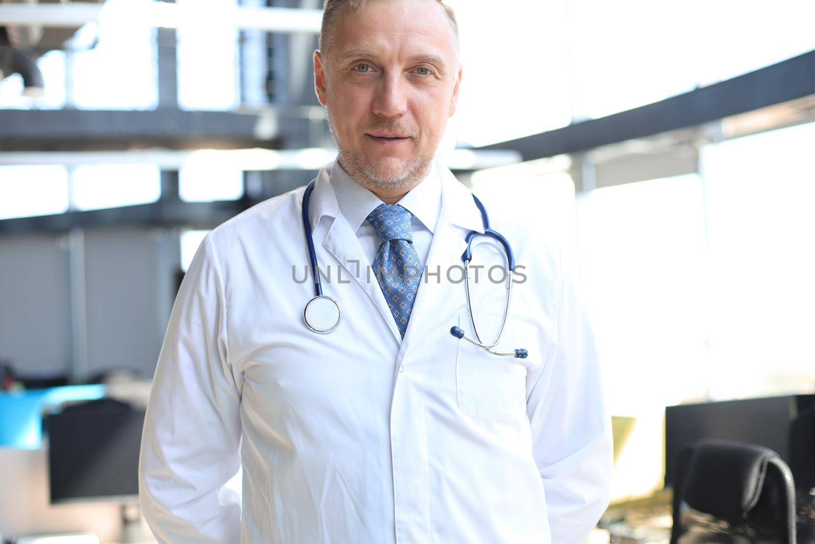Senior chief physician in white robe with stethoscope