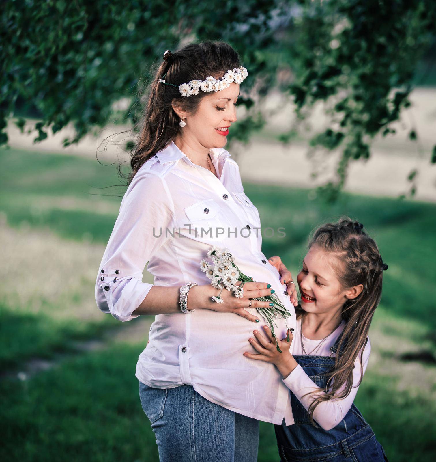 happy pregnant mom with her little daughter for a walk on a summer day. by SmartPhotoLab