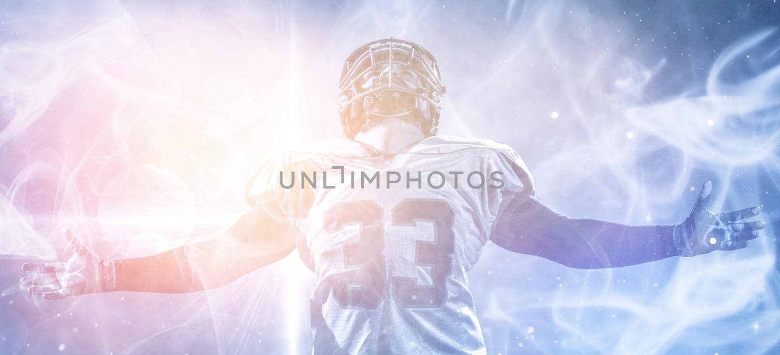 american football player celebrating after scoring a touchdown on the field of big modern stadium with lights and flares at night