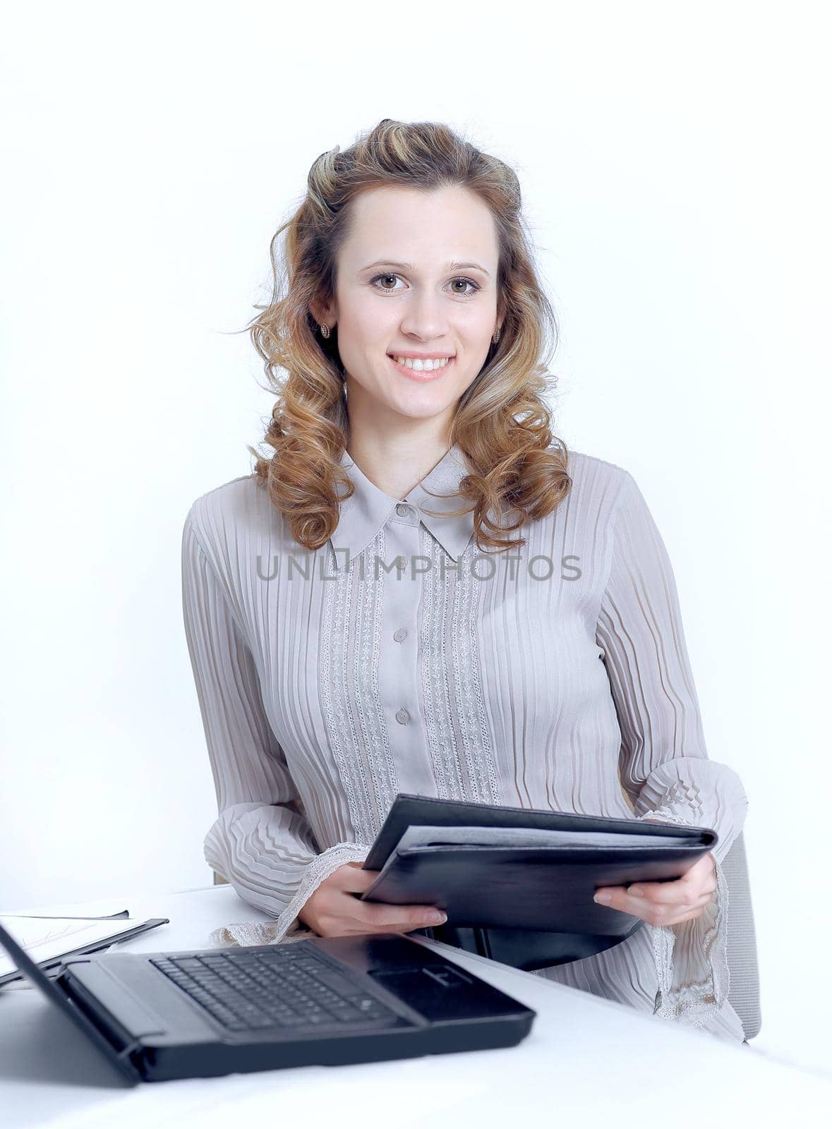 Executive female assistant with documents standing near desktop.photo with copy space.