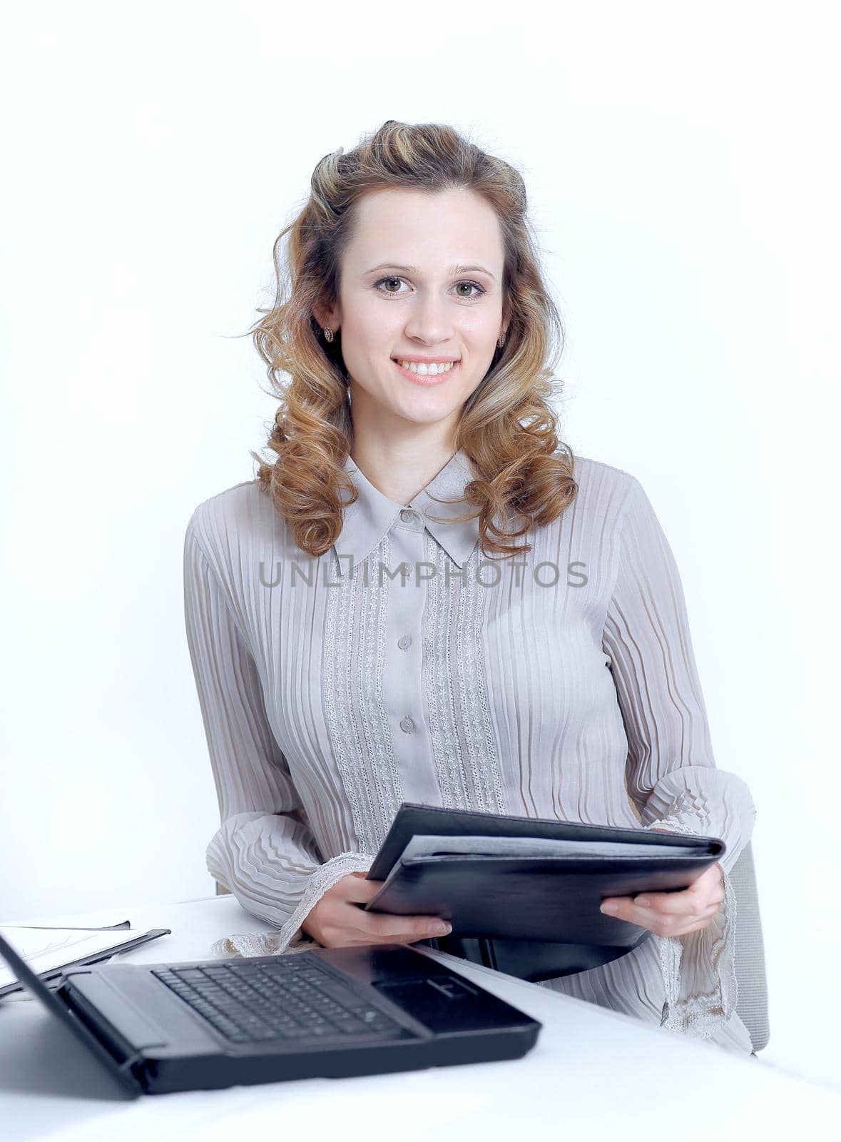 Executive female assistant with documents standing near desktop.photo with copy space.