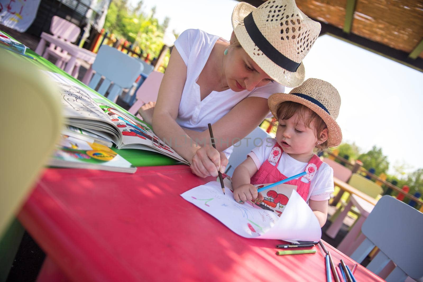 mom and little daughter drawing a colorful pictures by dotshock