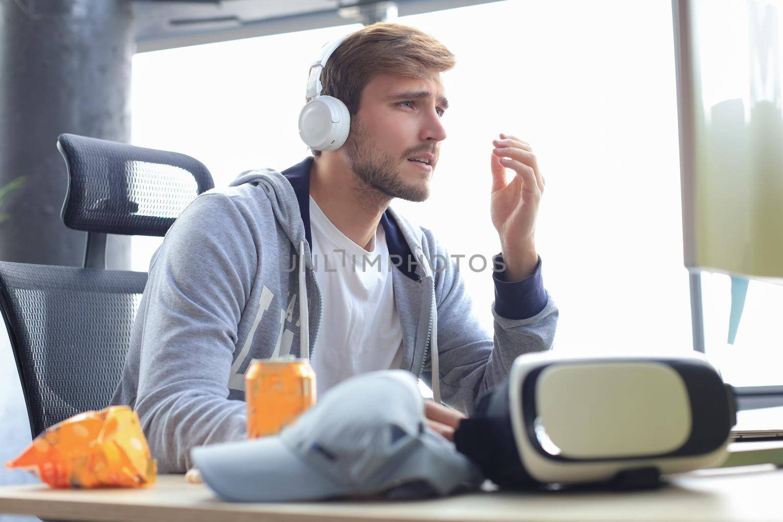 Young upset gamer playing online video games on computer and feel depressed