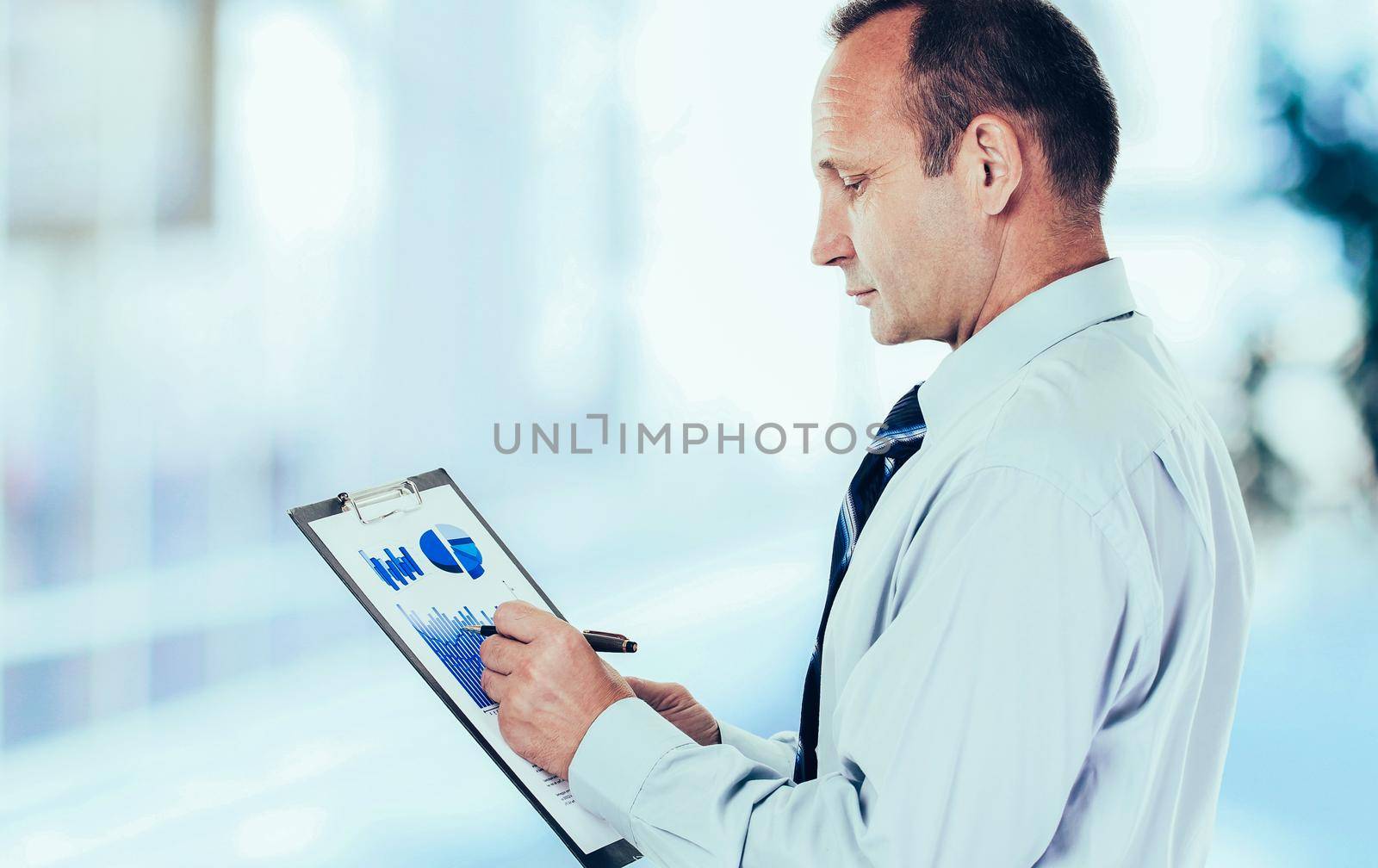 closeup -investor studies the financial schedule of revenues of the company.photo blurred background and has an empty space for your text