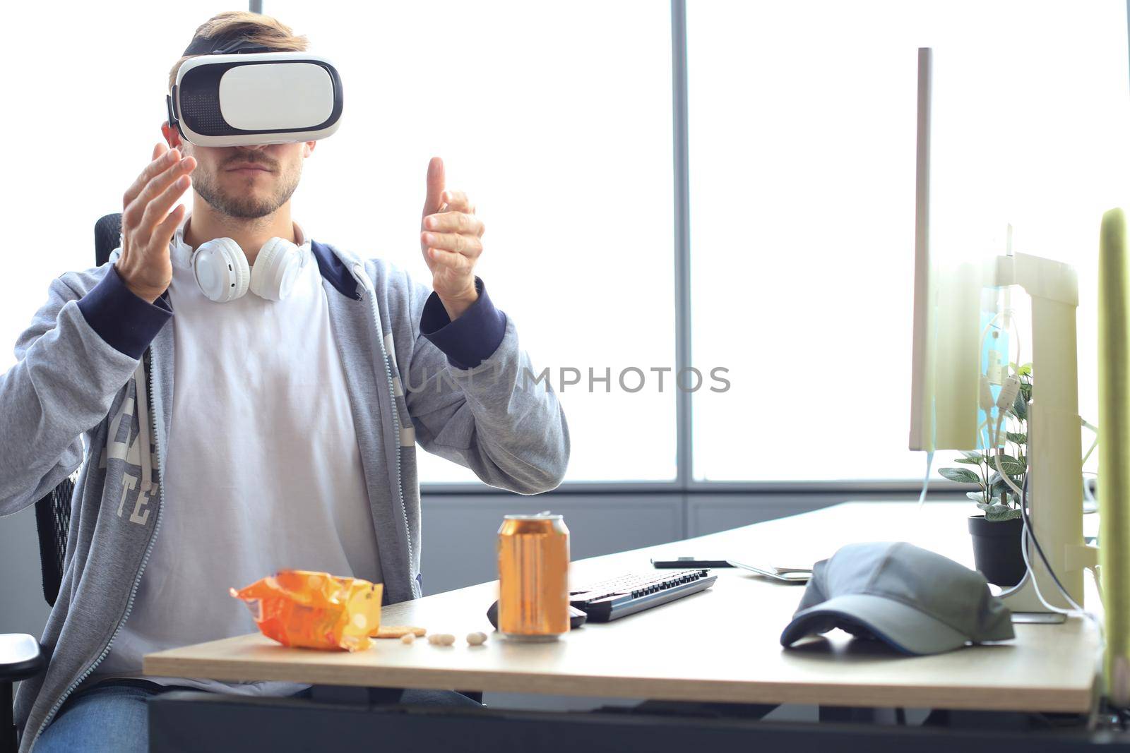 Young man playing game using virtual reality headset in the playing club