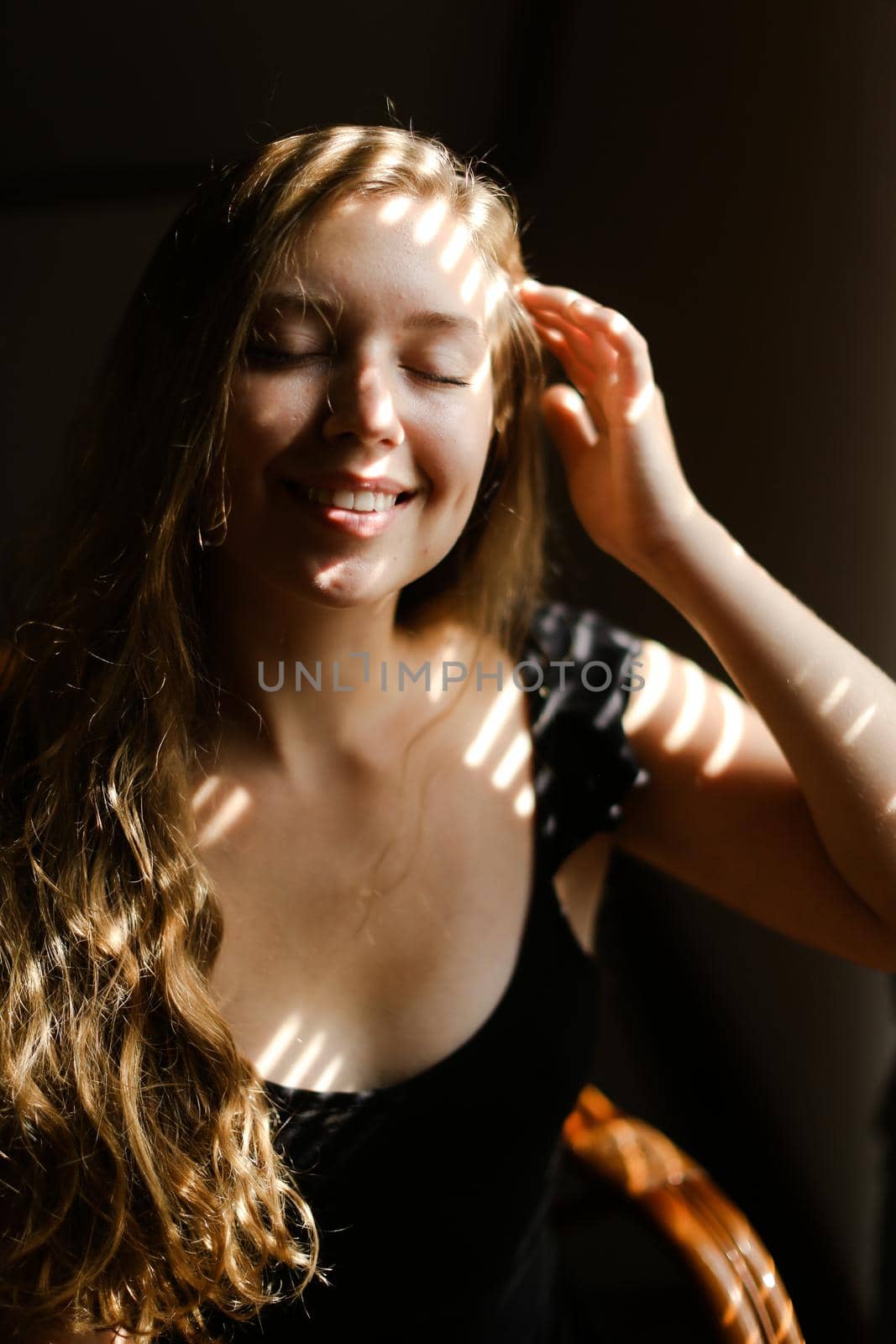 Close up portrait of young smiling woman with striped shadows. by sisterspro