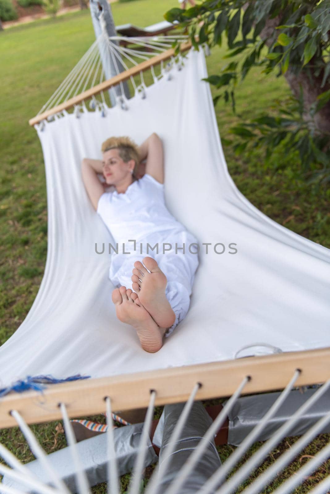 young woman resting on hammock by dotshock