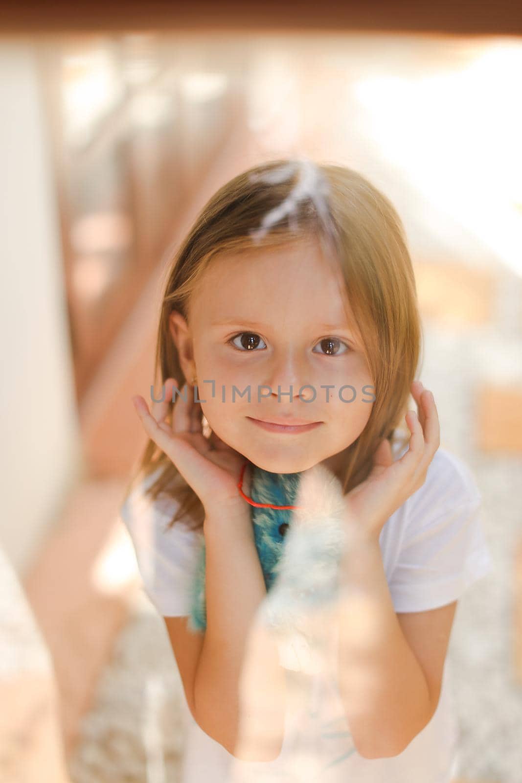 Portrait of little caucasian female kid with toy. Concept of child beauty and photosession for children.