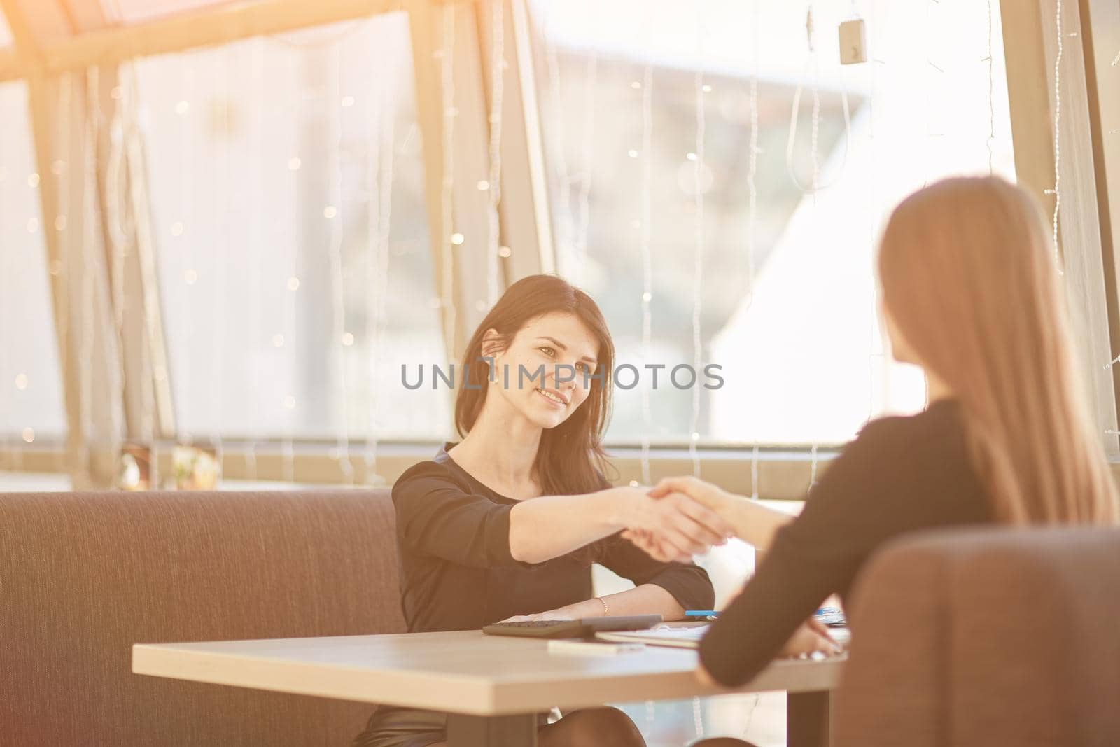 two business women shaking hands at an informal meeting. concept of cooperation