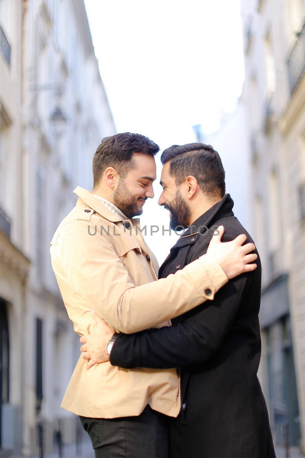 Two hugging american gays in city, buildings i background. by sisterspro