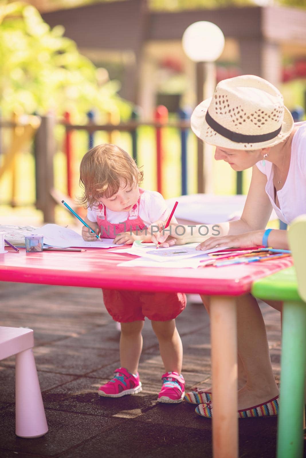 mom and little daughter drawing a colorful pictures by dotshock