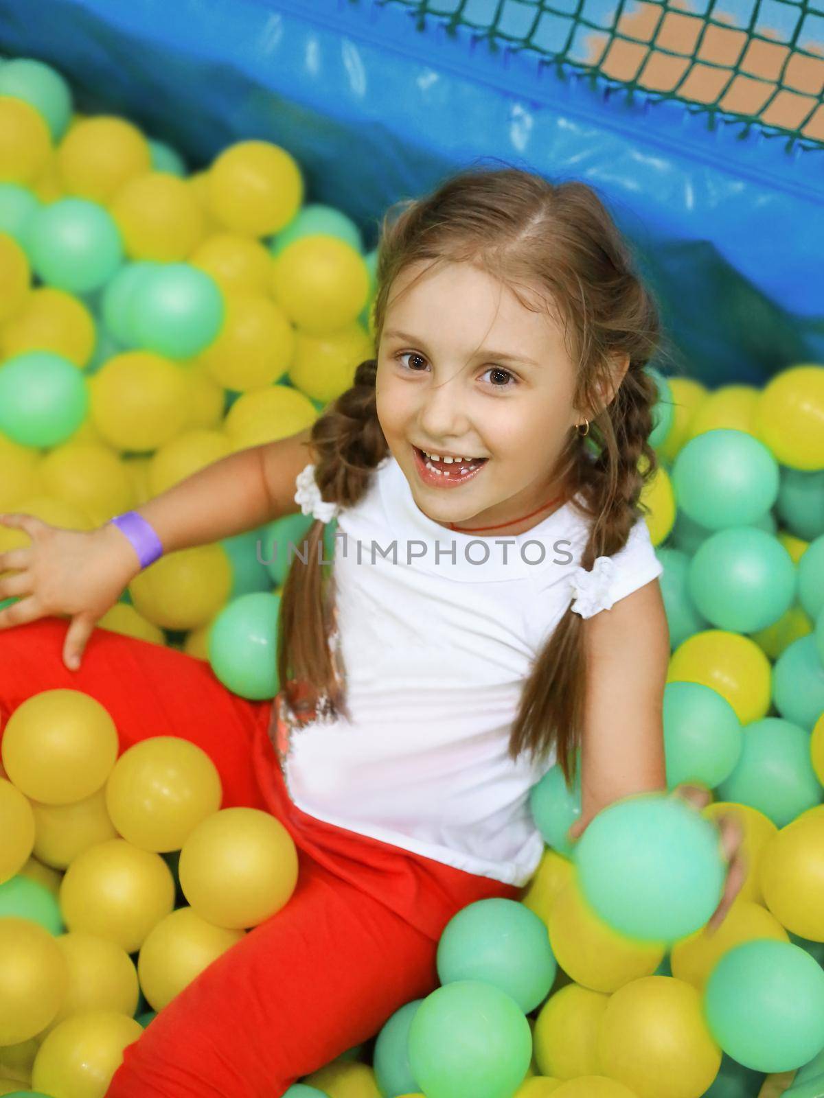 little girl with colorful balloons on the Playground .the concept of the celebration.