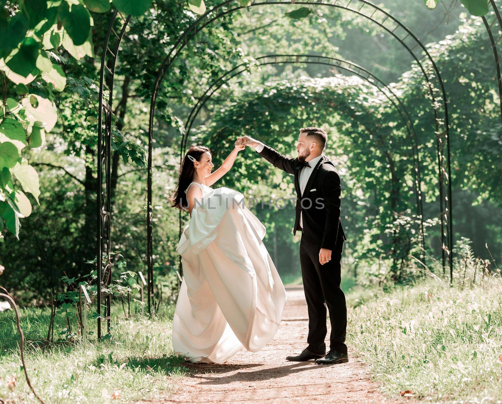 happy bride and groom dancing under the wedding arch. events and traditions