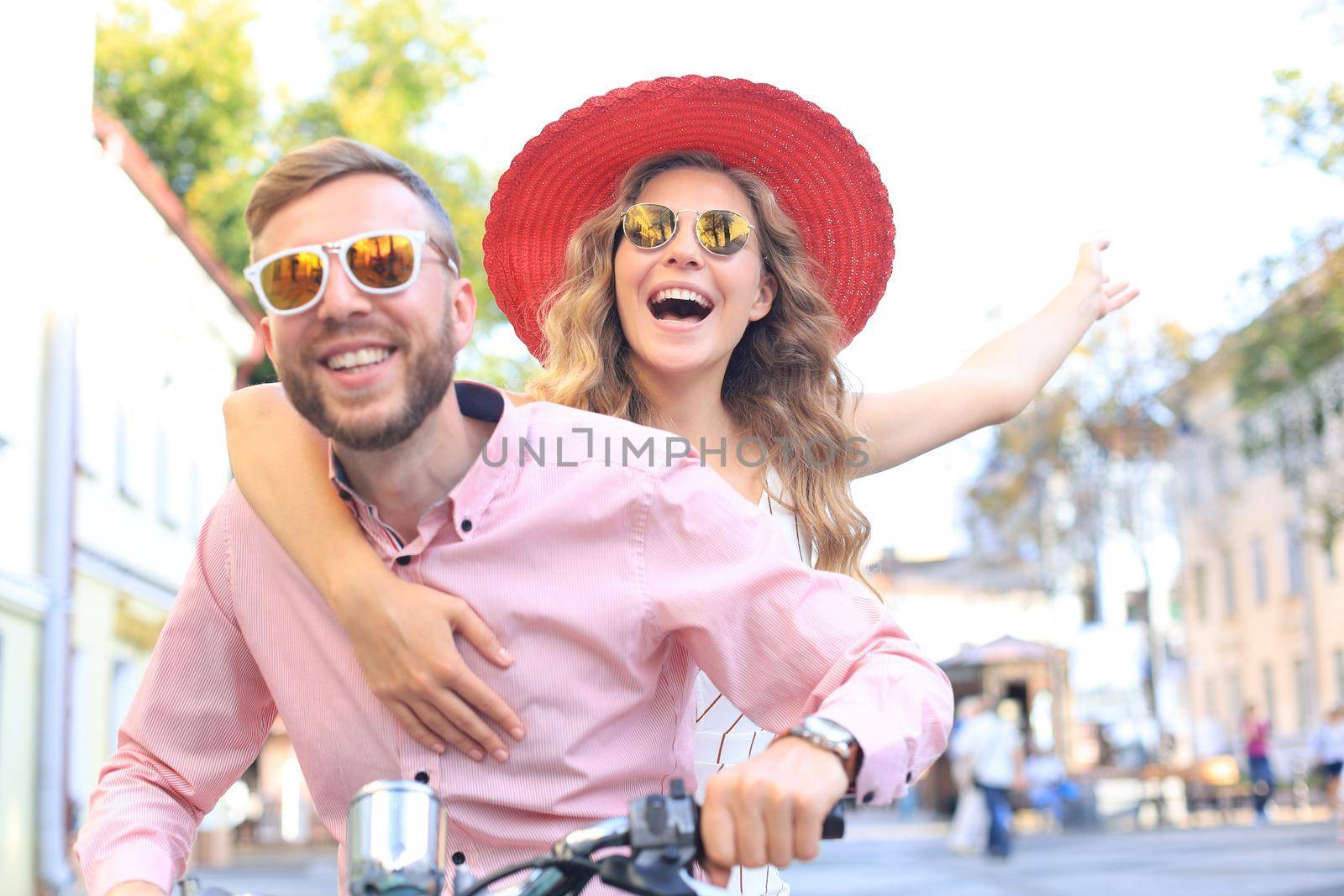 Young couple in love riding a motorbike. Riders enjoying themselves on trip. Adventure and vacations concept
