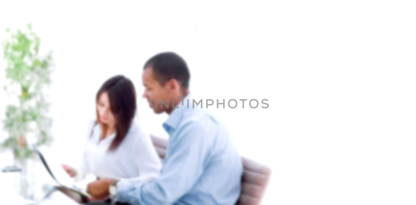 business colleagues discussing documents sitting at a Desk in the office. blurred image for the advertising text.