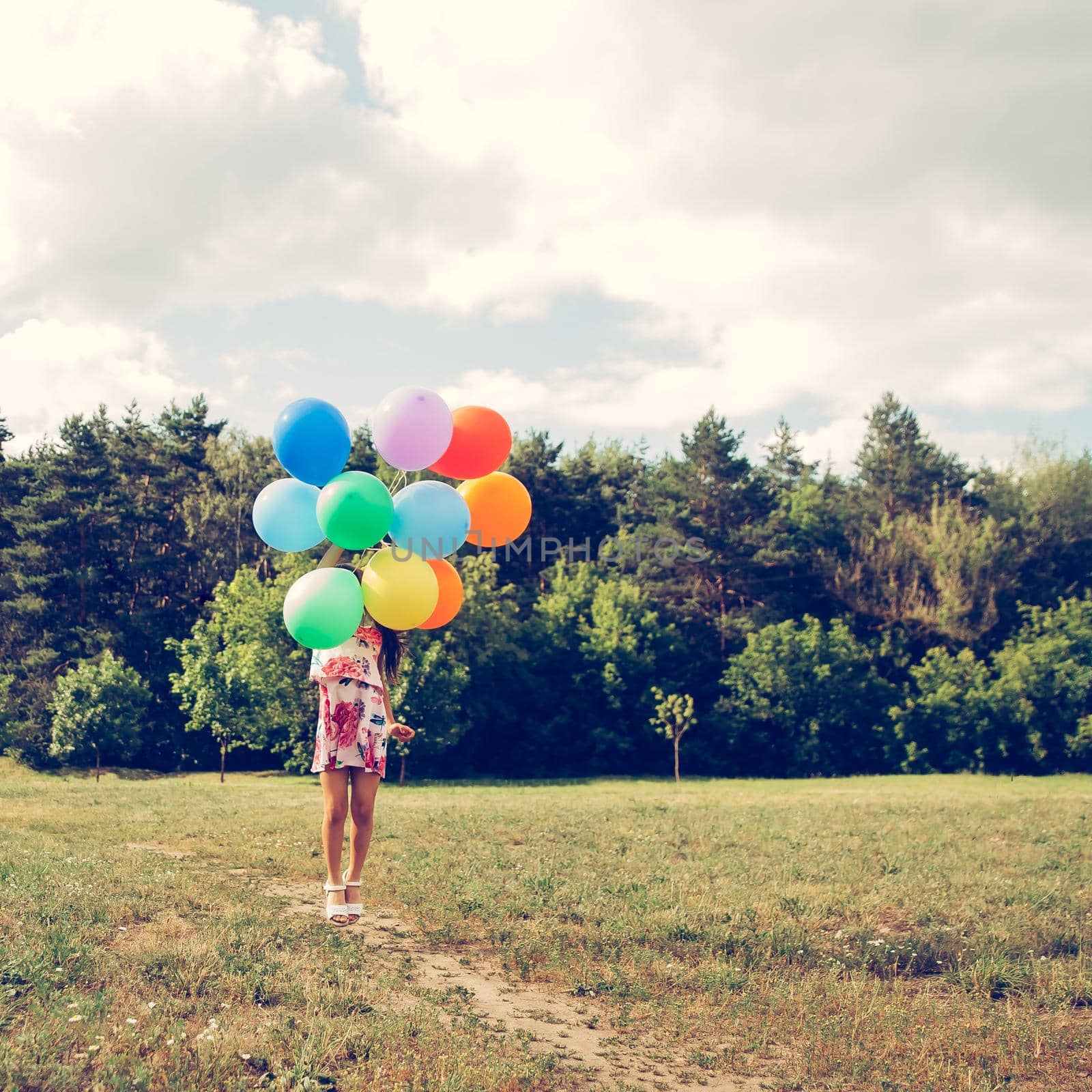 colorful balloons in the hands of a little girl. photo with copy space