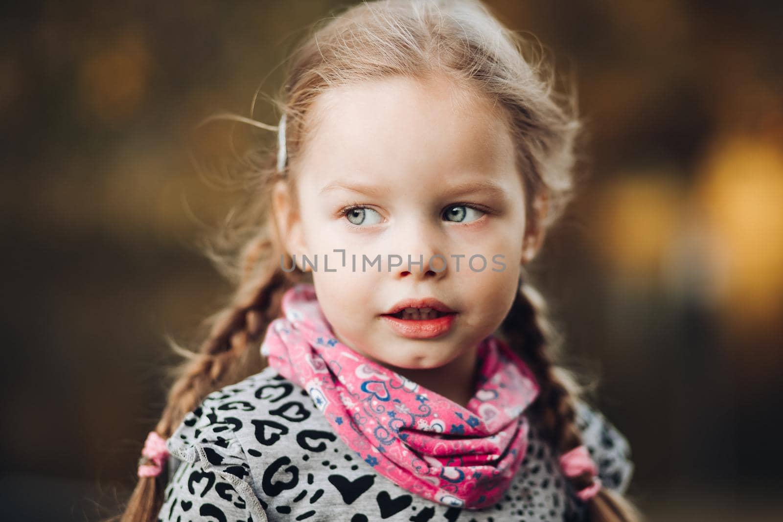 Handsome caucasian child in warm clothes looks aside