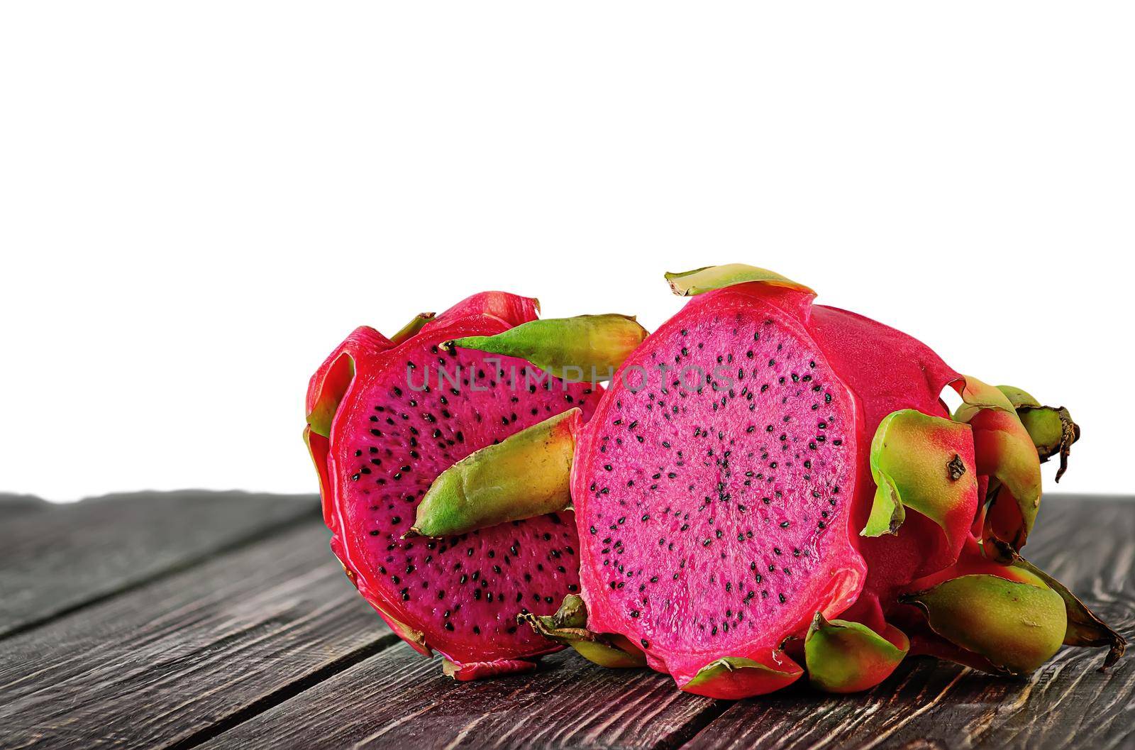 Two halves of dragon fruit on planks isolated on white background
