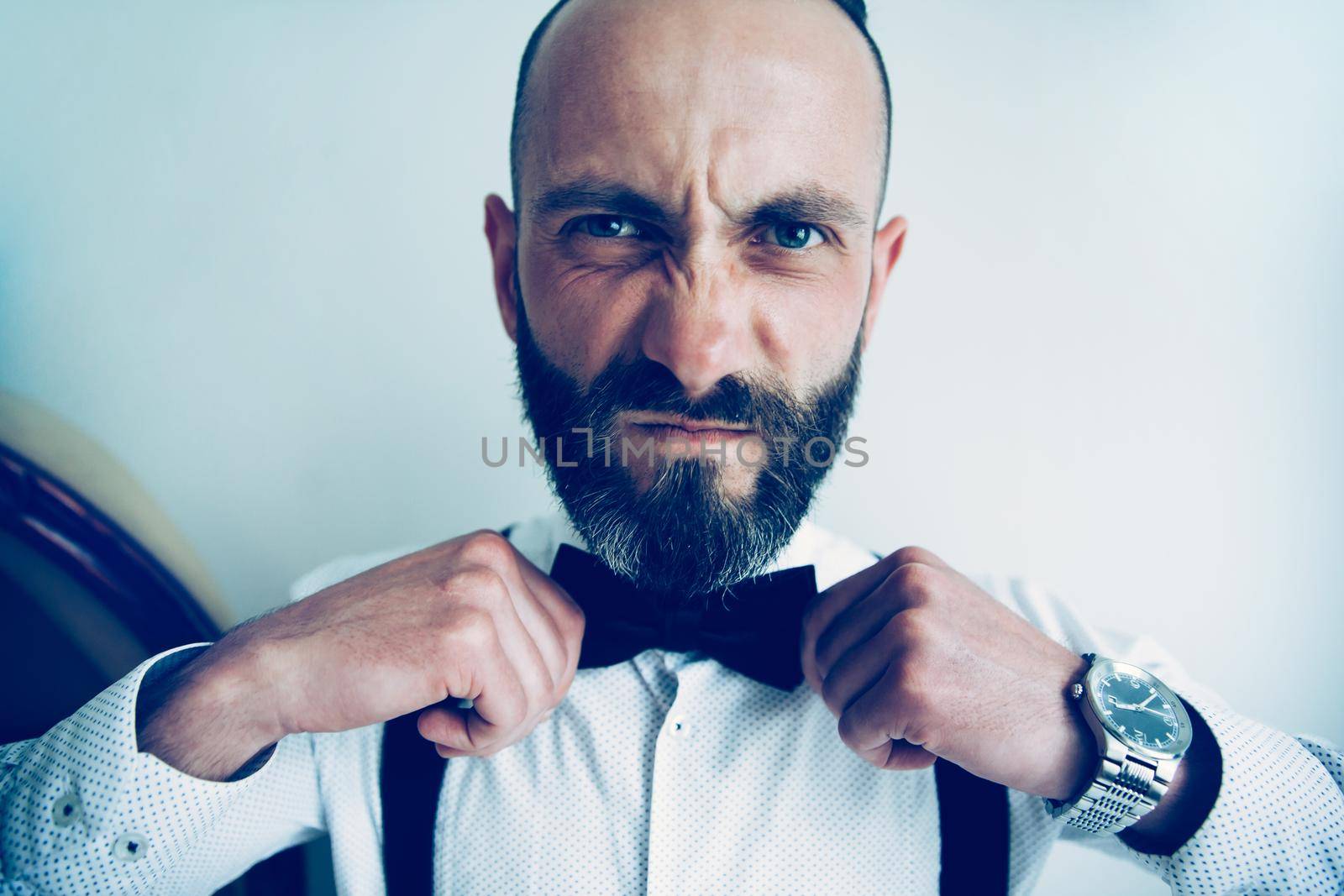 close up. man straightening his bow tie. people and emotions