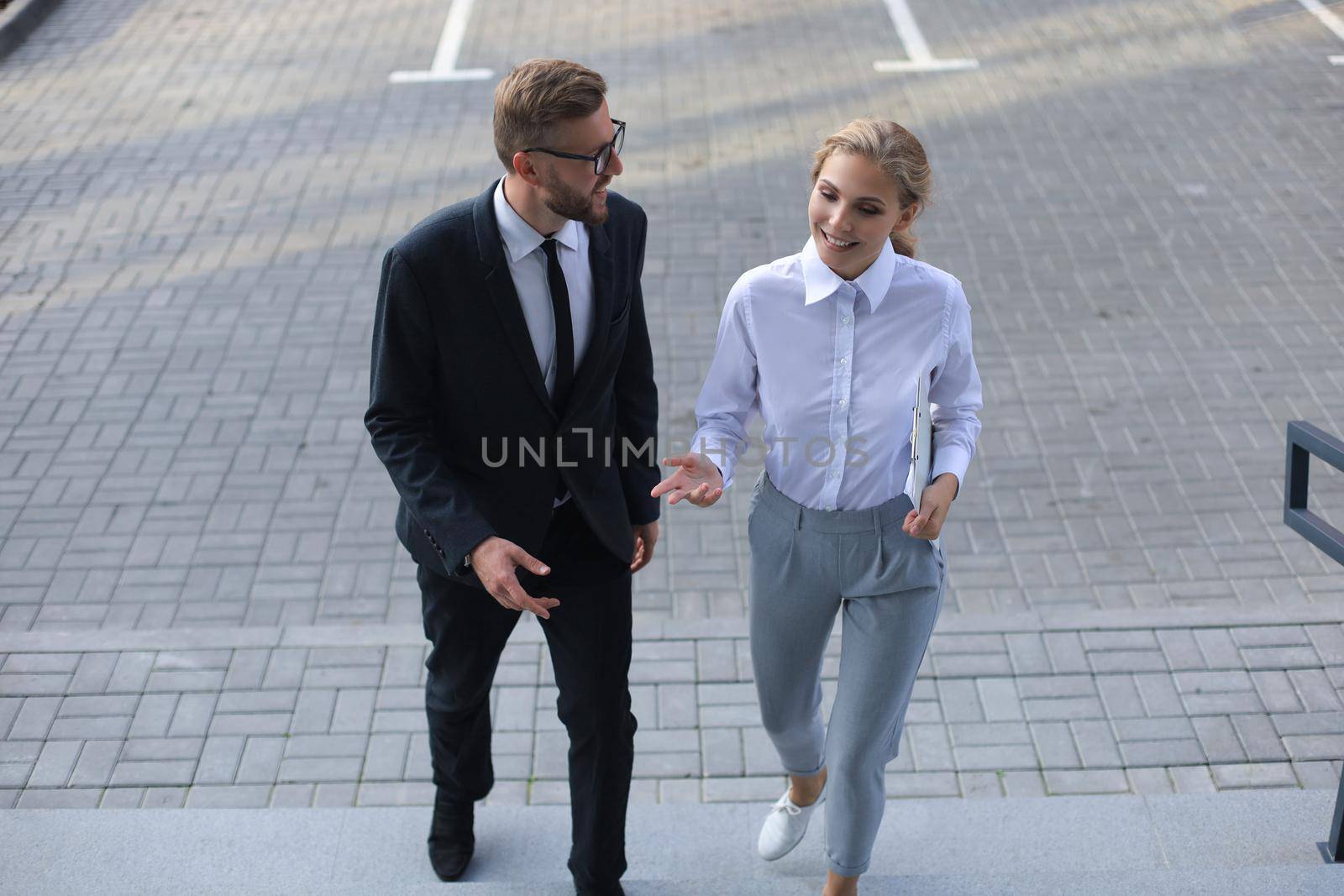 Business man and woman walking in the office center
