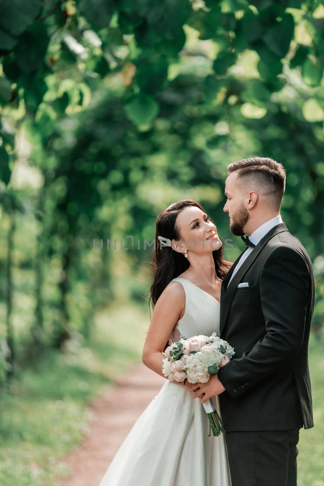 happy bride and groom standing under the wedding arch. events and traditions