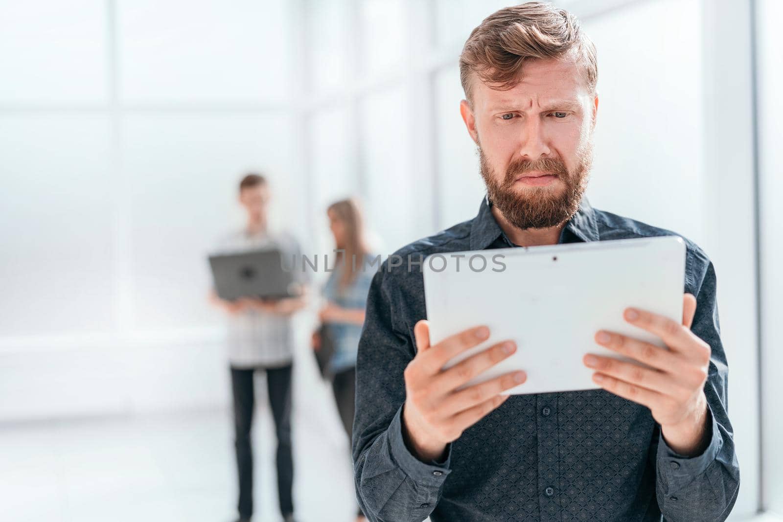 emotional businessman looking at the screen of his tablet. photo with copy space