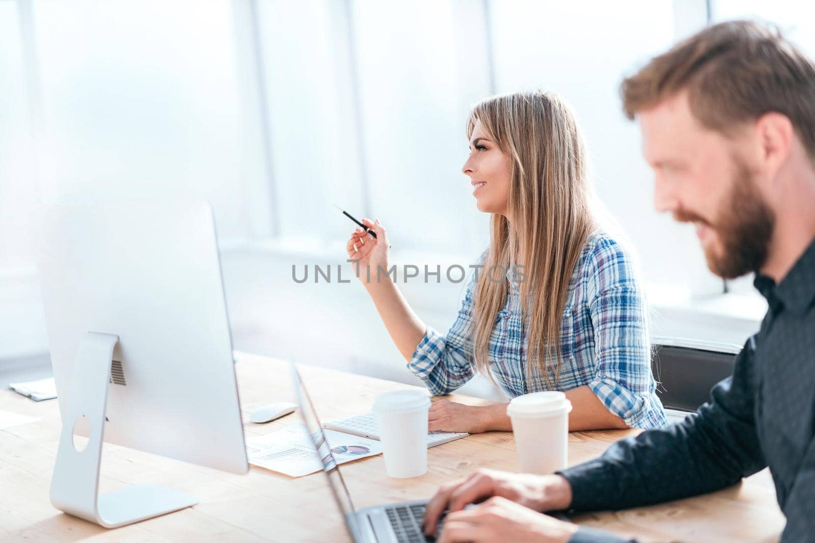 young employees discussing work issues in the workplace. office weekdays