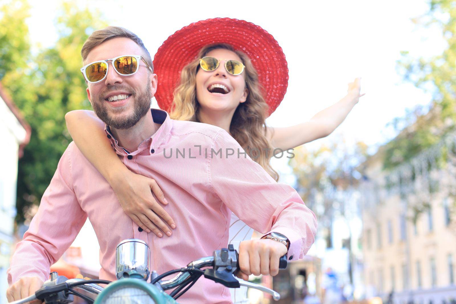 Young couple in love riding a motorbike. Riders enjoying themselves on trip. Adventure and vacations concept. by tsyhun