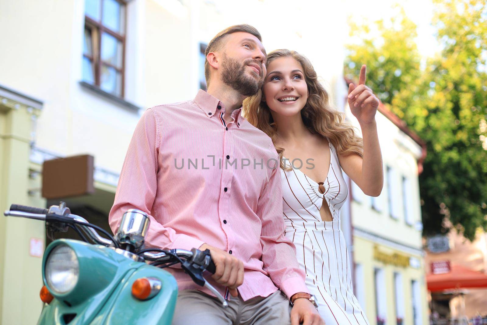 Young beautiful couple riding on motorbike. Adventure and vacations concept