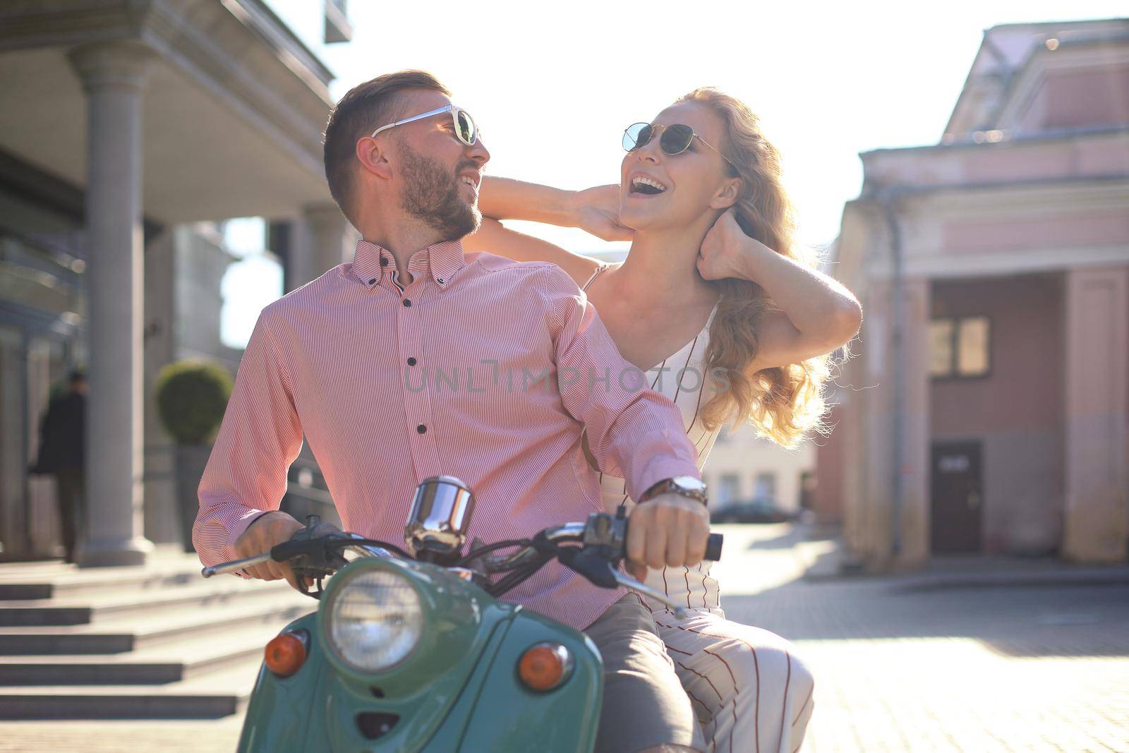 Young couple in love riding a motorbike. Riders enjoying themselves on trip. Adventure and vacations concept. by tsyhun