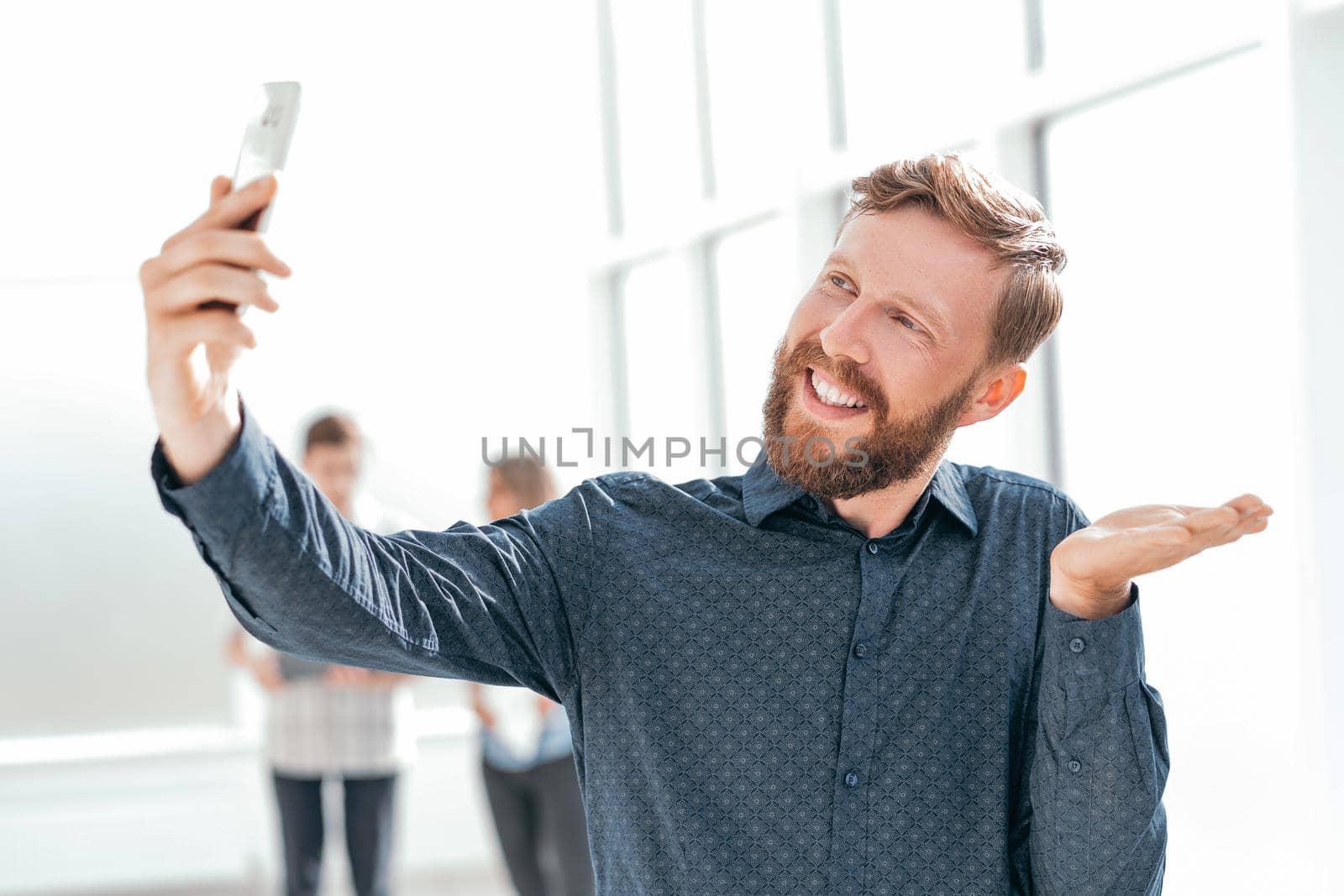 smiling businessman explaining something to his interlocutor on video communication by SmartPhotoLab