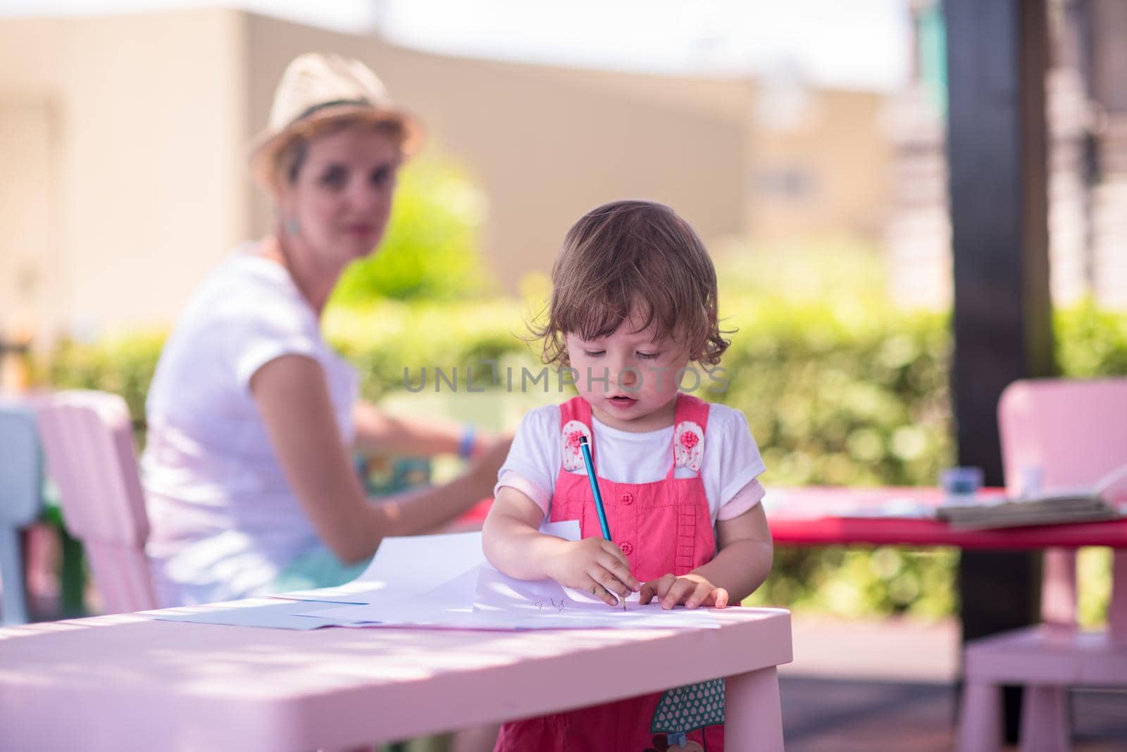 mom and little daughter drawing a colorful pictures by dotshock