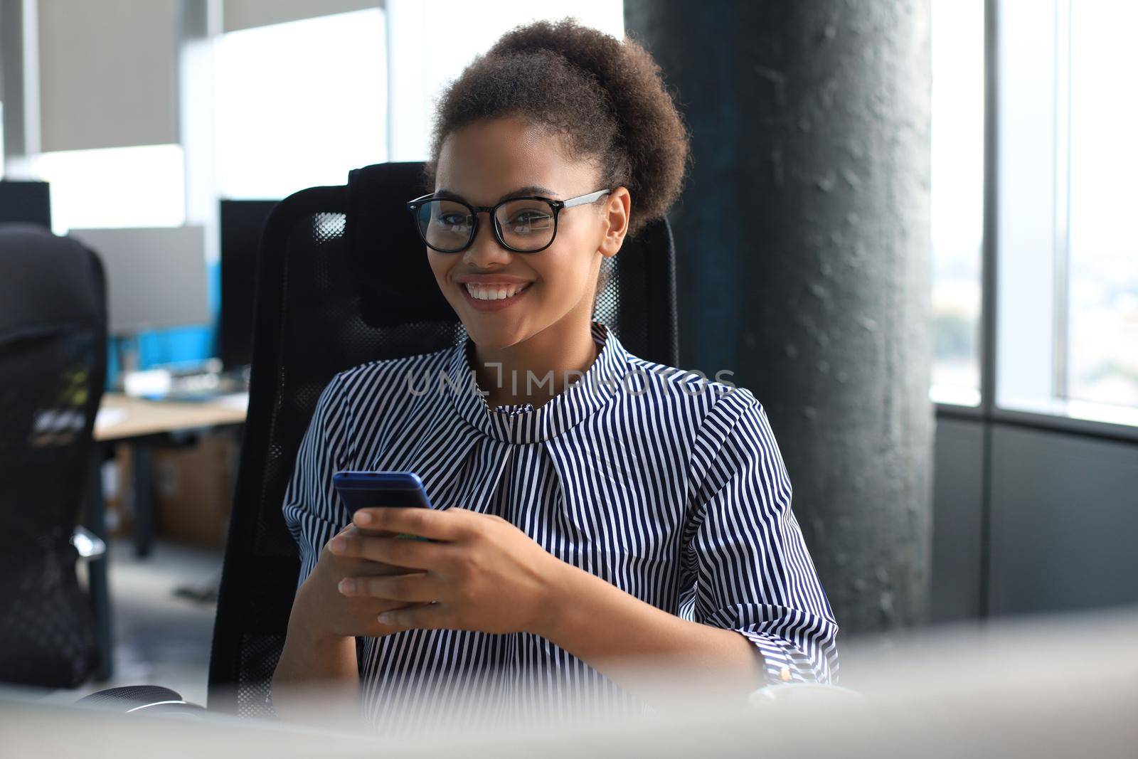 Beautiful afro american woman using mobile phone. Communication concept. by tsyhun