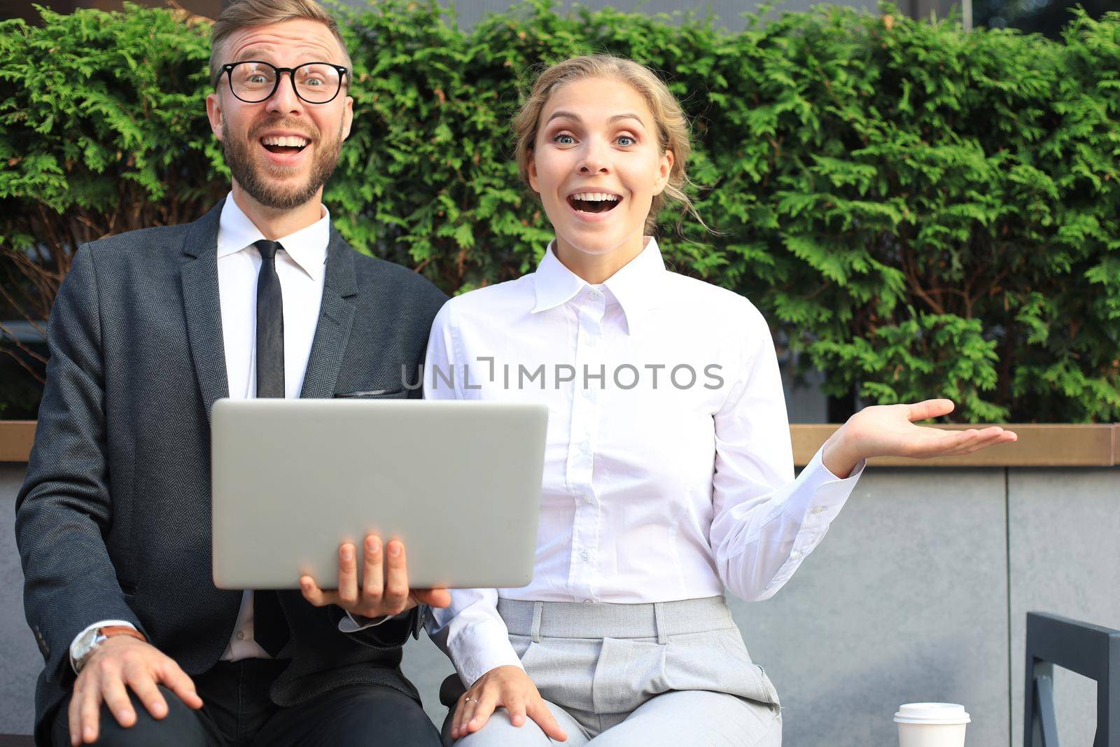 Business people surprised by information from laptop