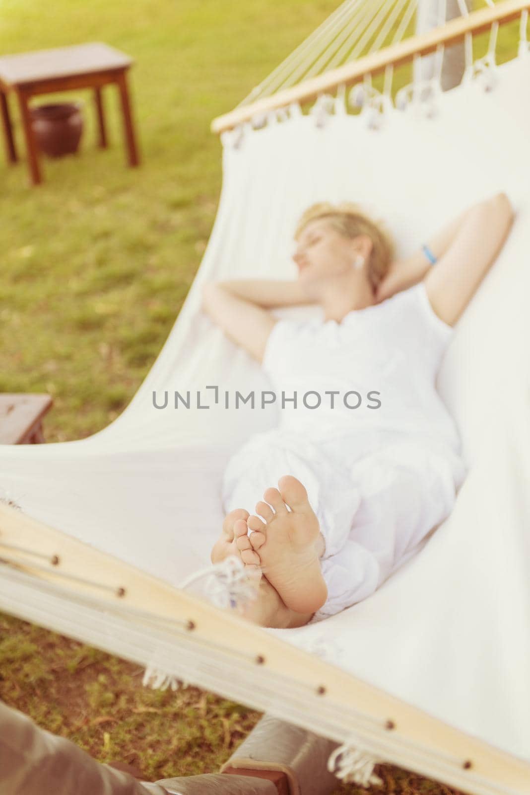 young woman resting on hammock by dotshock