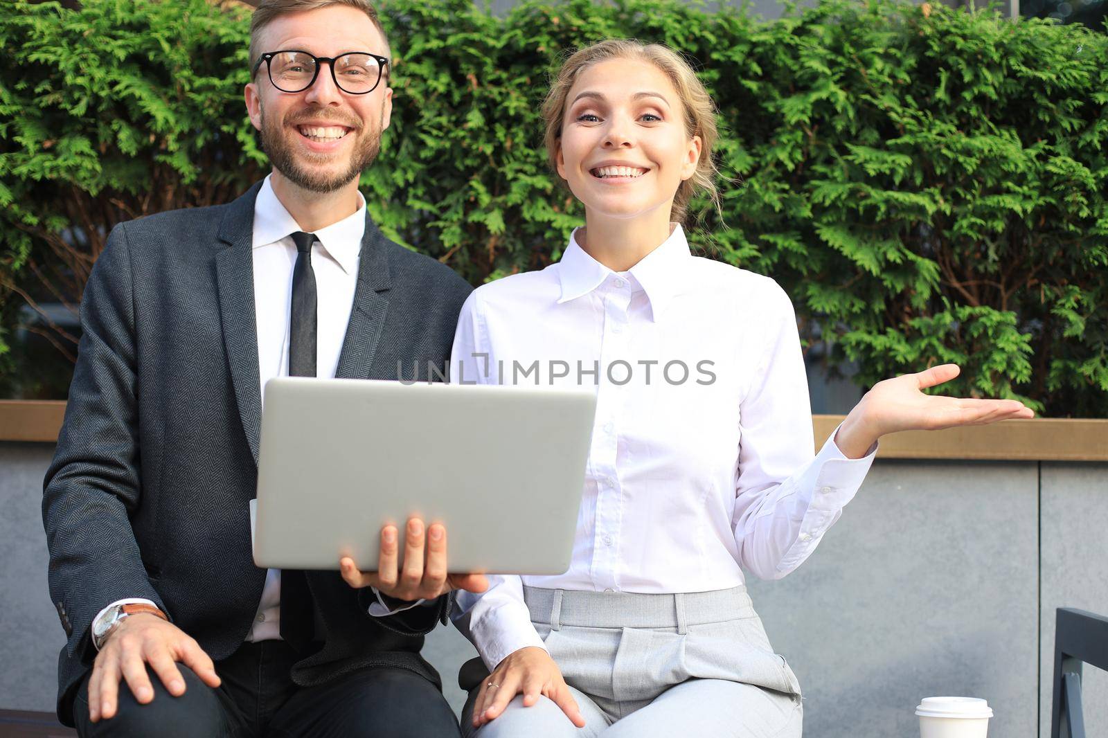 Business people surprised by information from laptop. by tsyhun