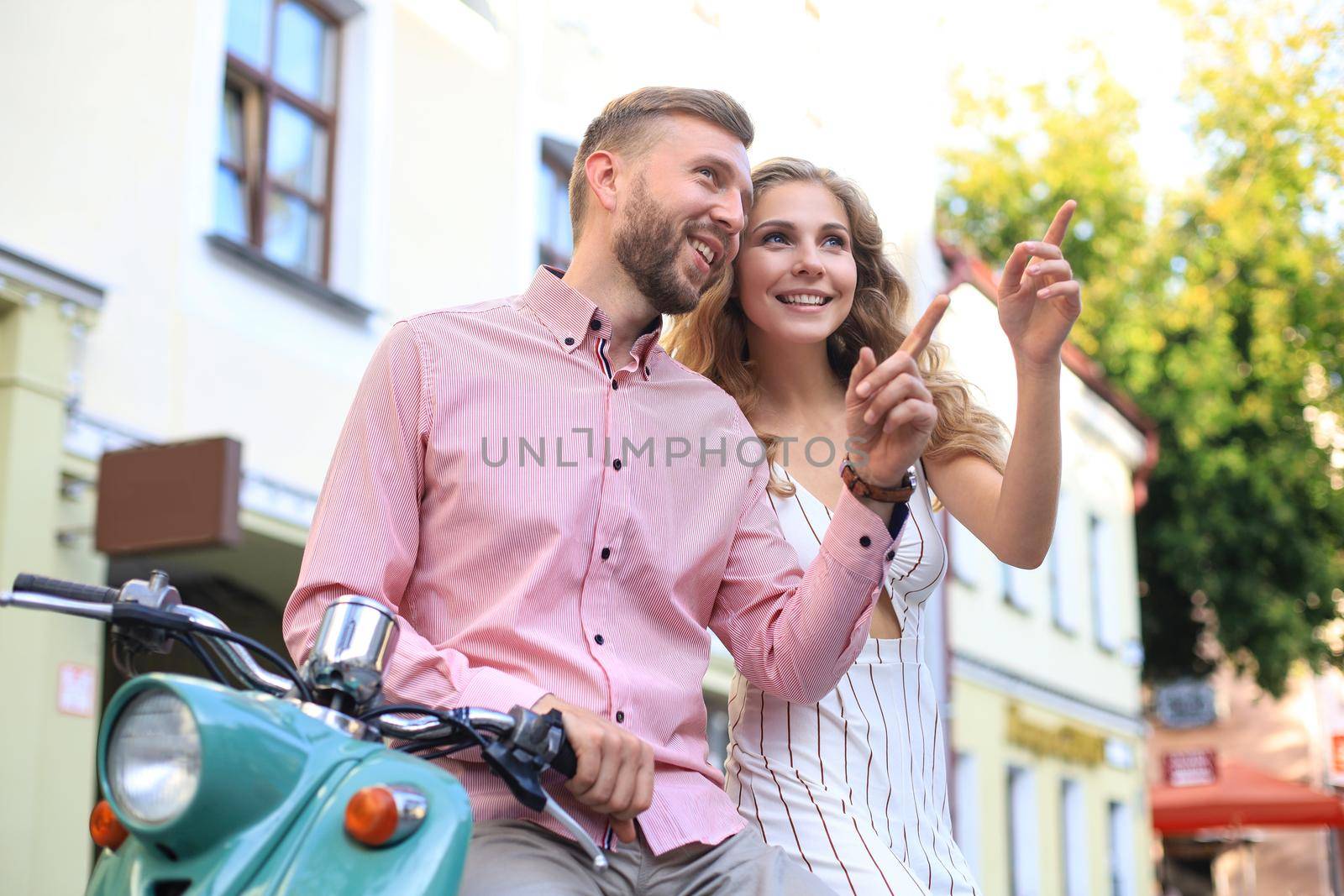 Young beautiful couple riding on motorbike. Adventure and vacations concept. by tsyhun