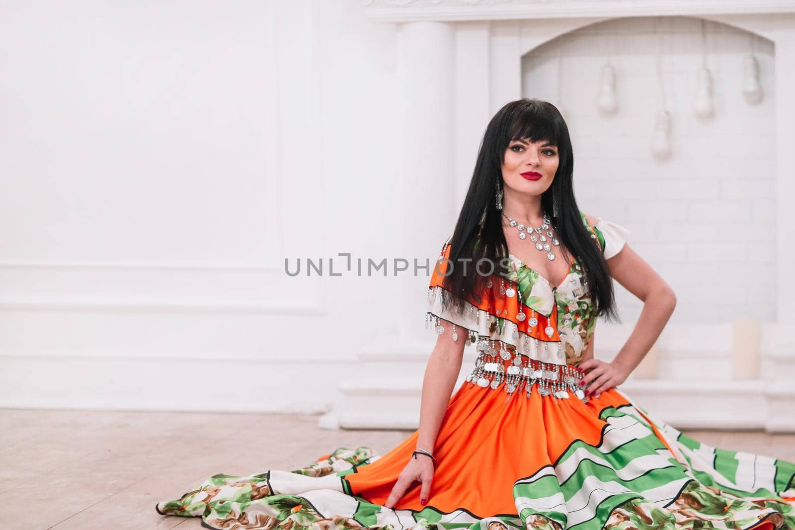 attractive young Gypsy woman sitting in a chair. photo with copy space