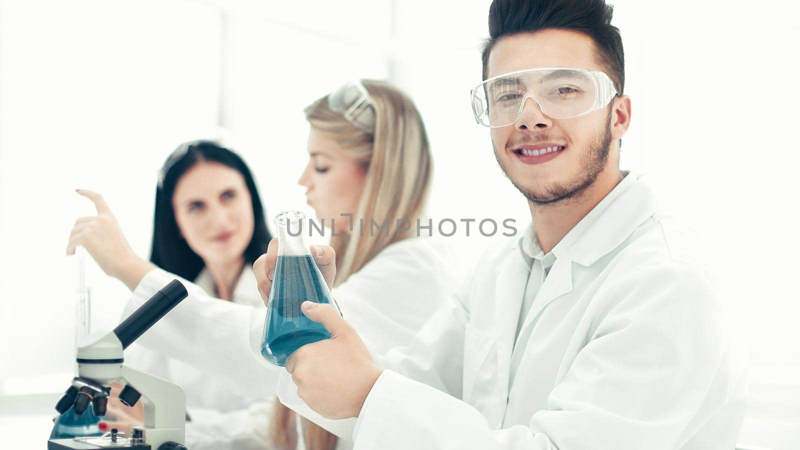 man scientist holding a flask of liquid for the experiment. science and health