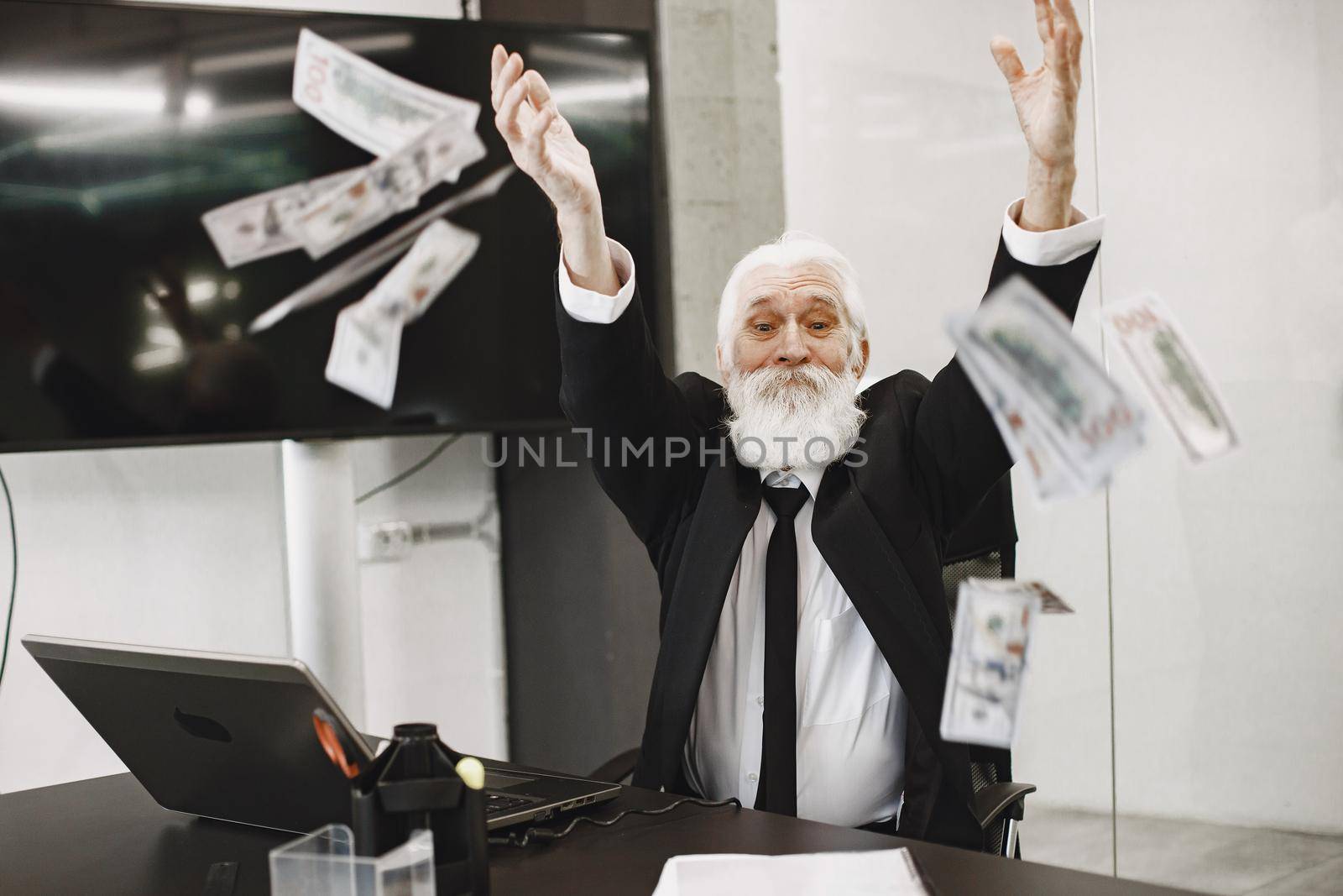 Old-fashioned man sitting at the table. Elegant man at the office. Senior with a money.