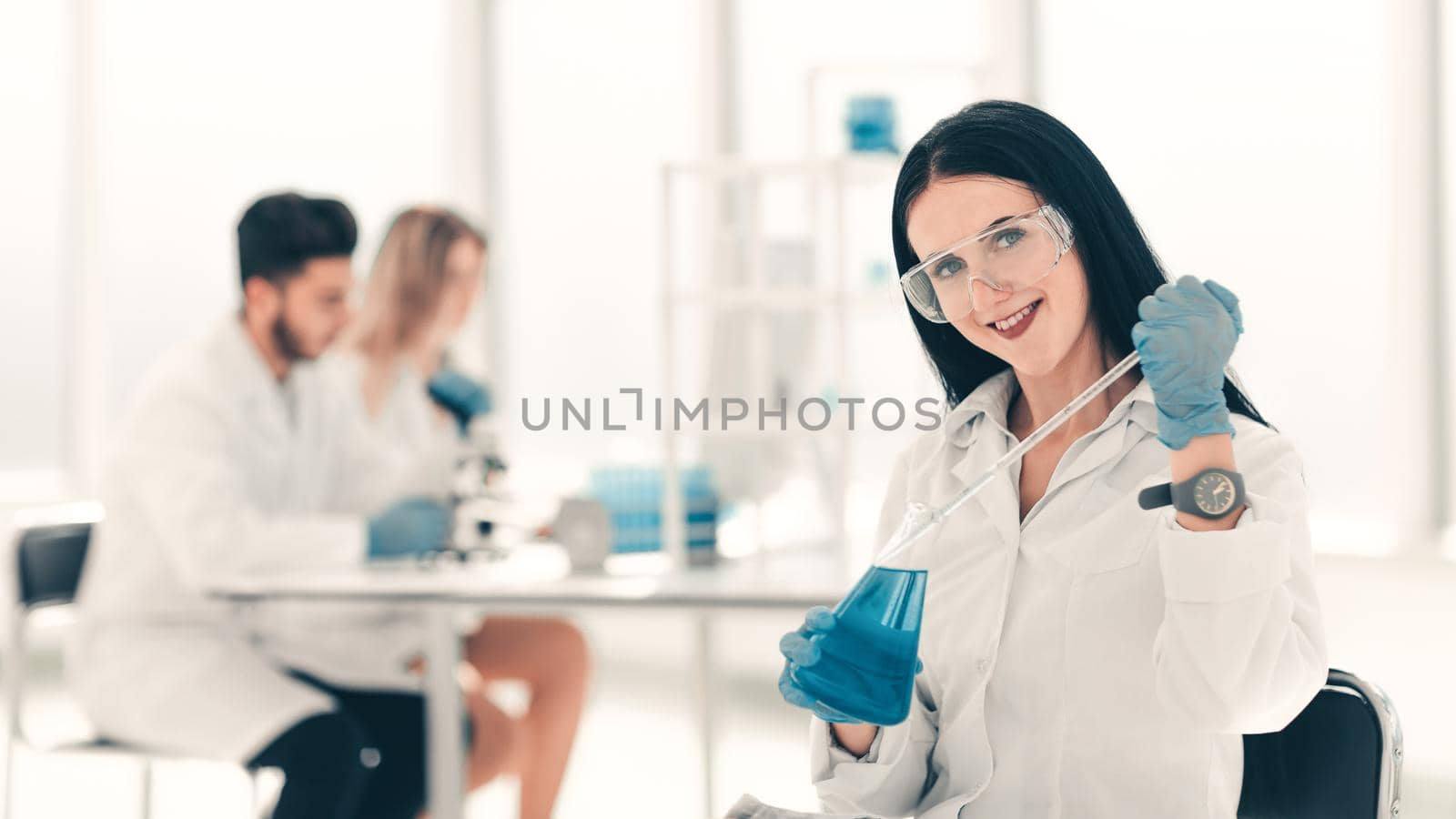 close up.woman scientist takes a sample of the liquid . photo with copy space