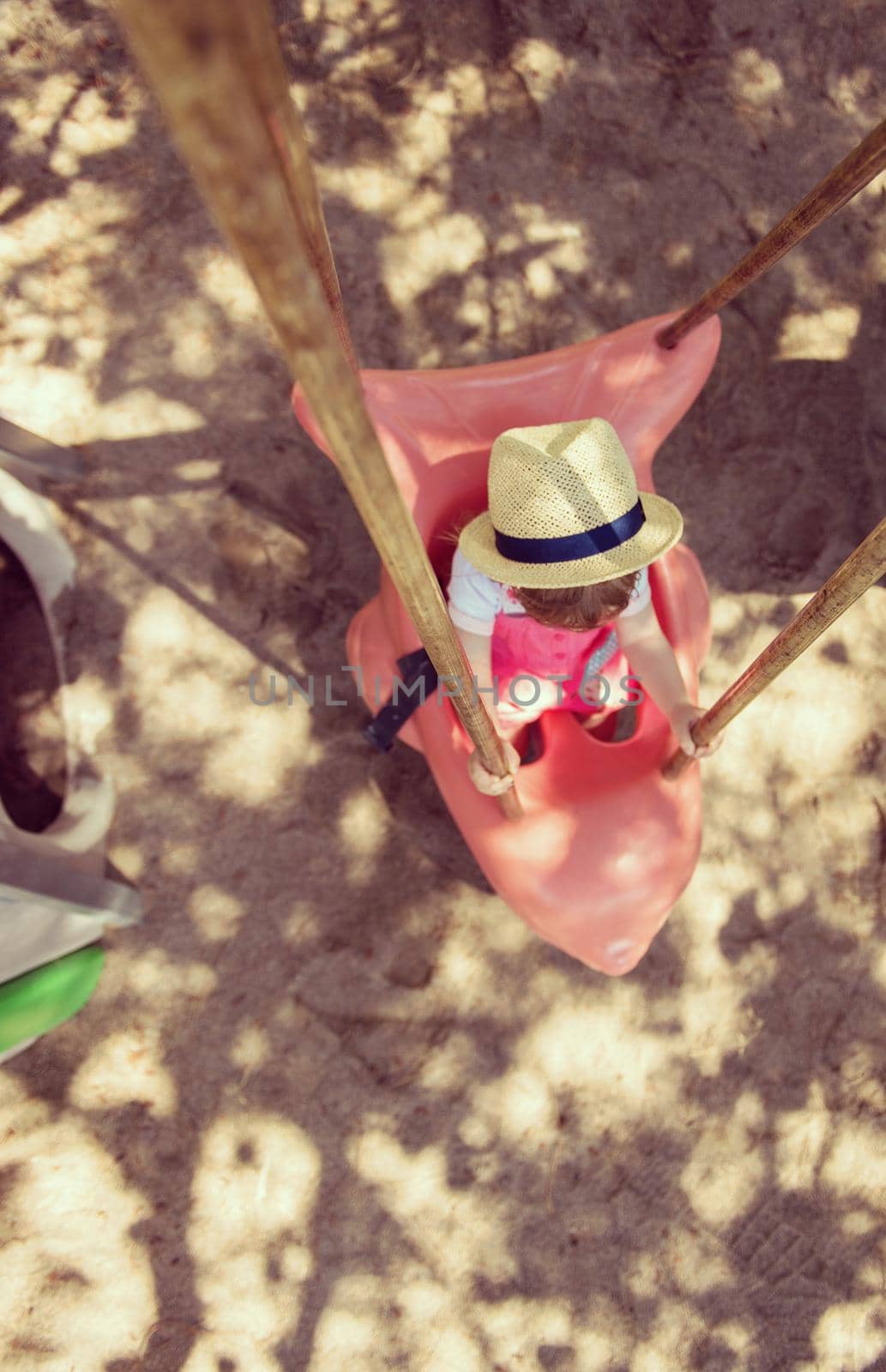 little girl swinging  on a playground by dotshock