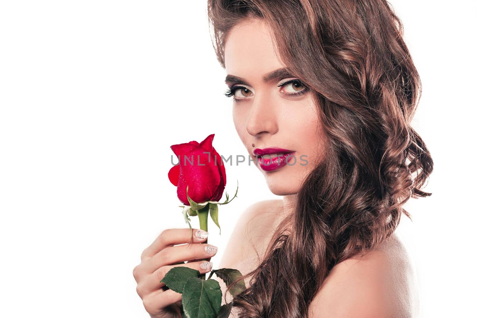 side view. stylish young woman with red rose . isolated on white background