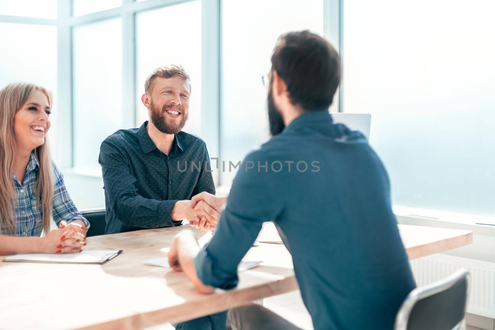 Manager shaking hands with the applicant during the interview. the concept of employment