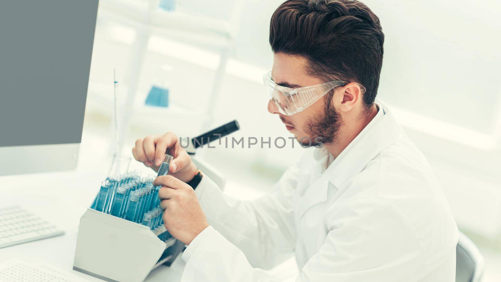 modern scientist examines test tube with liquid. science and health