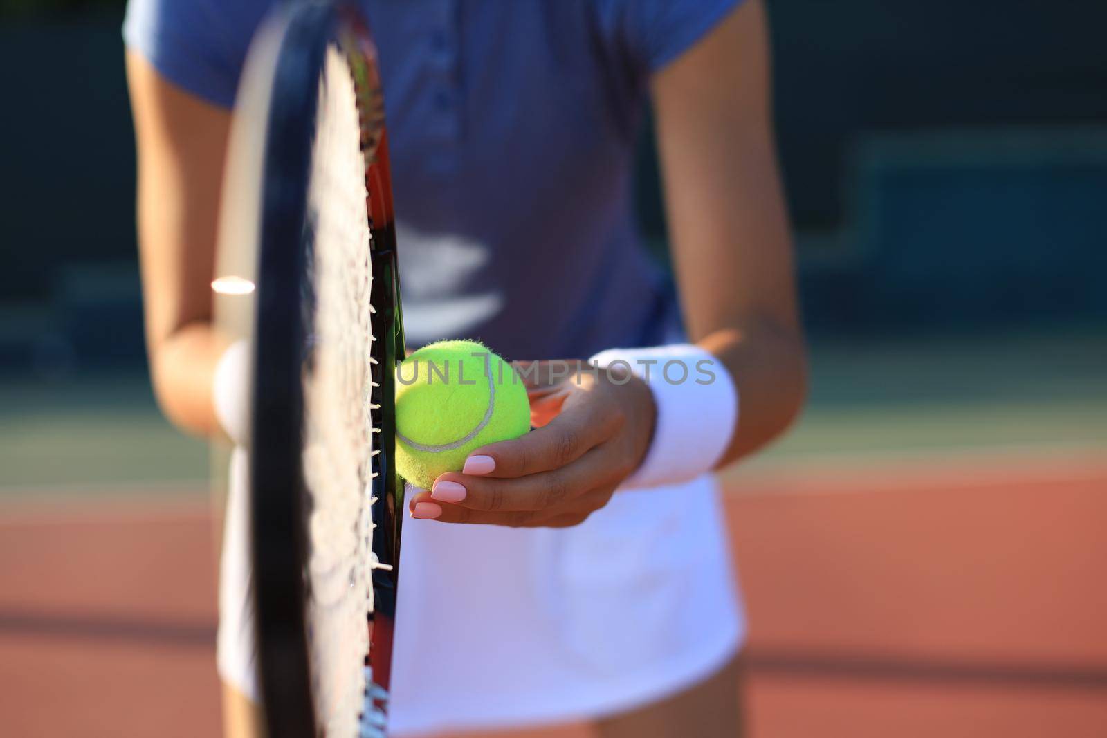 Close up of a tennis player hitting the ball with racket. by tsyhun