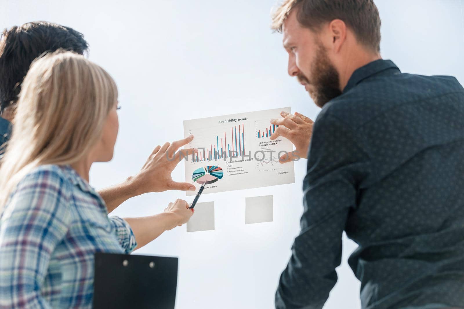 young employees pointing pen on financial graph . business concept